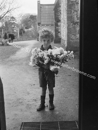 LITTLE BOY WITH FLOWERS FOR CHURCH